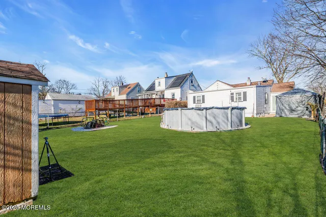 a view of a house with a big yard and potted plants