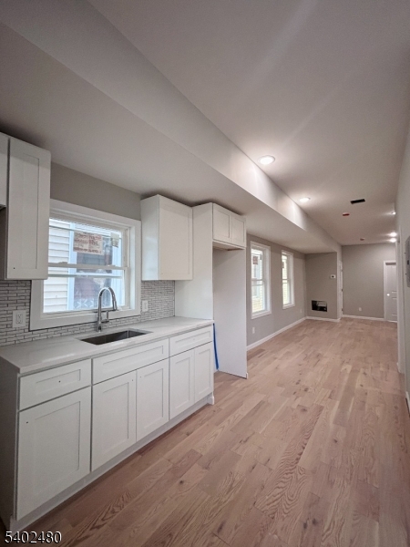 788 East 18th Street, Unit 2 Paterson, NJ 07501 - Photo 7 of 9 a kitchen with granite countertop a sink and cabinets