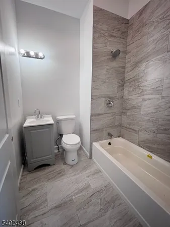 a bathroom with a sink a toilet and bathtub