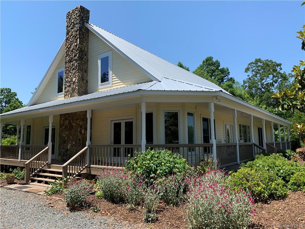 6026 Fish Road Marshville, NC 28103 - Photo 14 of 45 a view of a house with potted plants and a table and chairs