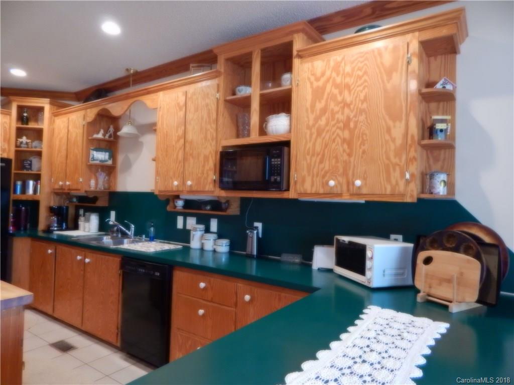 6026 Fish Road Marshville, NC 28103 - Photo 22 of 45 a kitchen with stainless steel appliances granite countertop a sink and a microwave