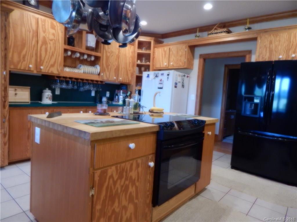 6026 Fish Road Marshville, NC 28103 - Photo 23 of 45 a kitchen with a stove and a refrigerator