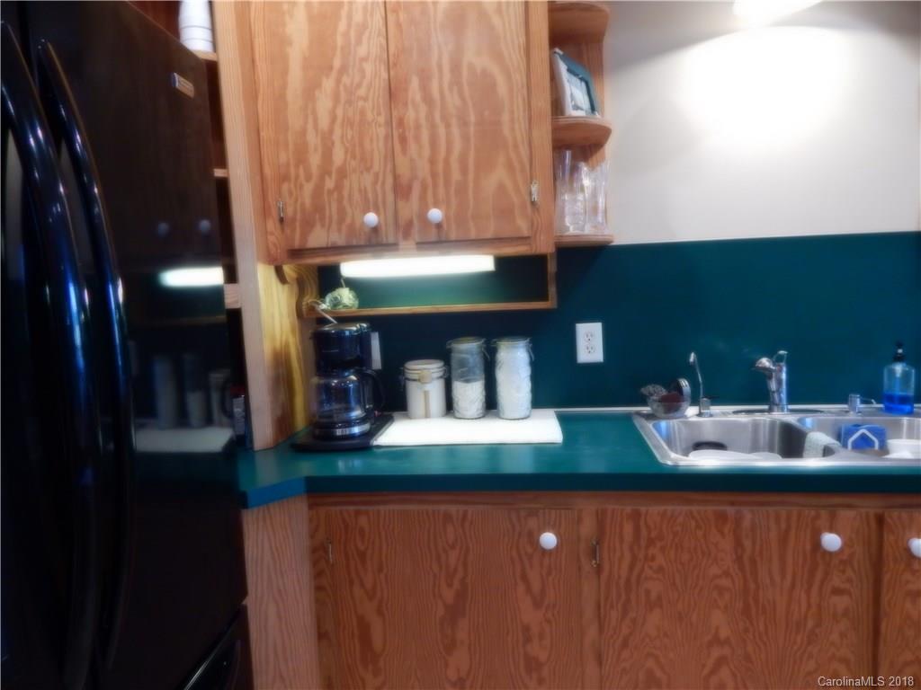 6026 Fish Road Marshville, NC 28103 - Photo 25 of 45 a kitchen with kitchen island granite countertop a sink and cabinets