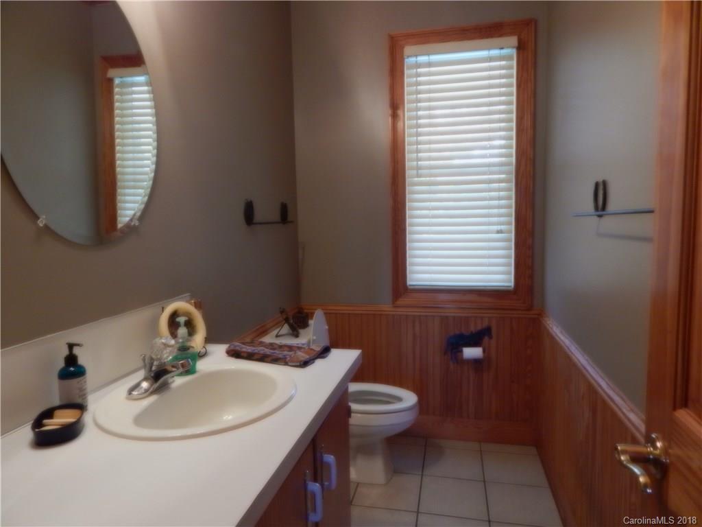 6026 Fish Road Marshville, NC 28103 - Photo 27 of 45 a bathroom with a sink a toilet and a mirror