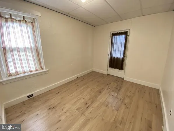 a view of a room with wooden floor and fan