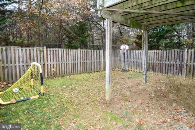 a view of a backyard with a small cabin and chair