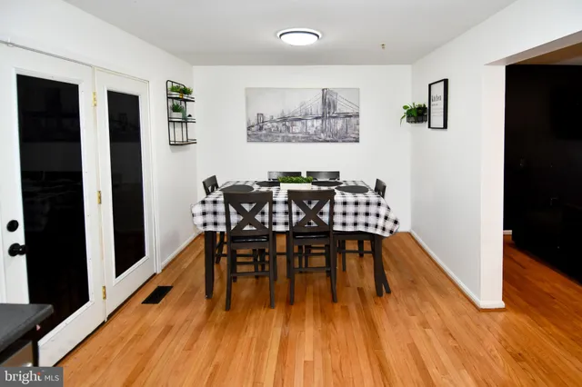 a dining room with furniture and wooden floor