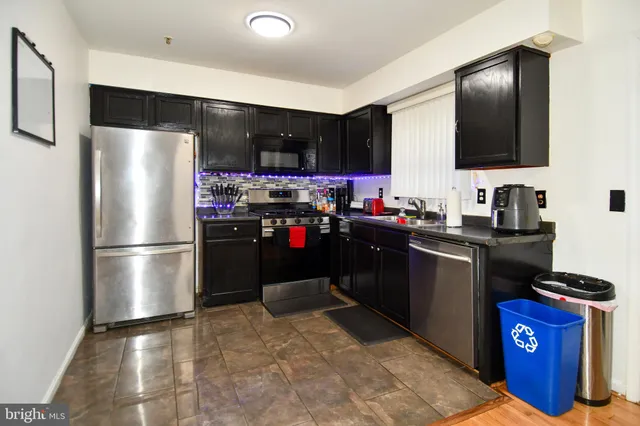 a kitchen with a refrigerator sink and stove