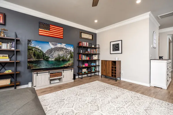 a living room with fireplace furniture and a flat screen tv