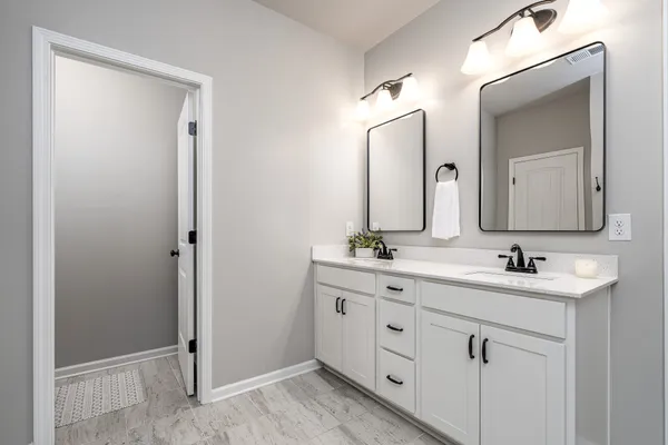 a bathroom with a glass shower door