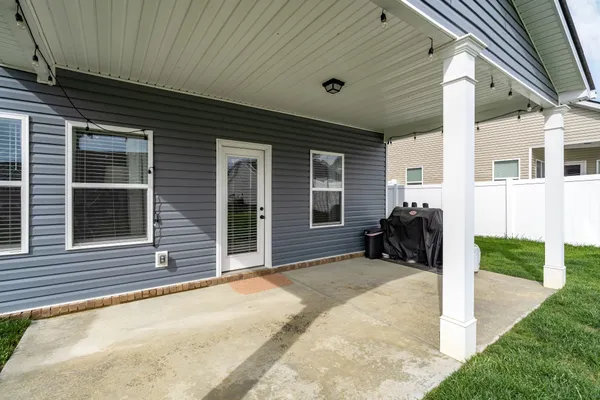 a view of a house with backyard and porch