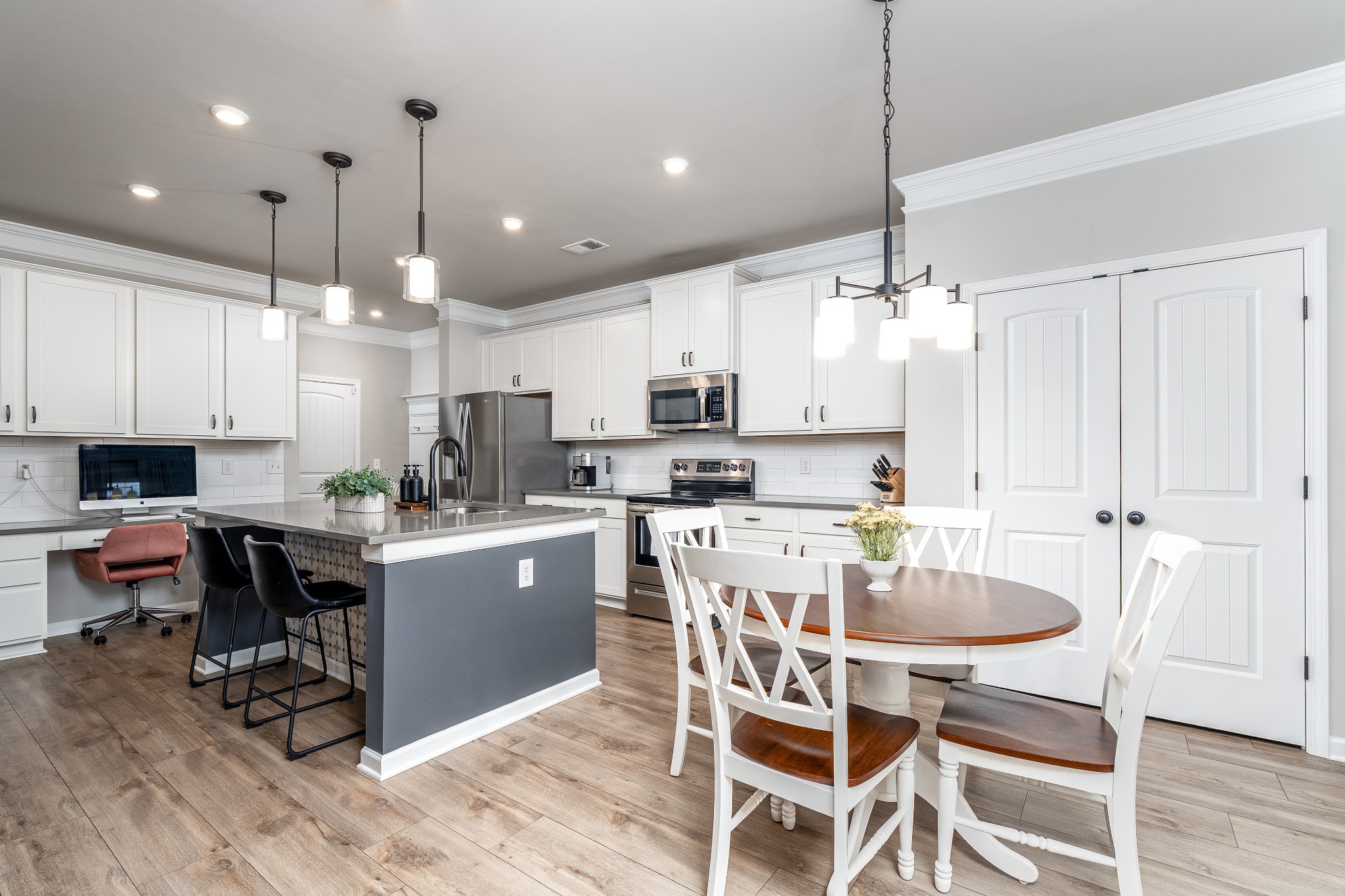 2991 Timewinder Way Columbia, TN 38401 - Photo 10 of 33 a kitchen with kitchen island granite countertop a dining table chairs and white cabinets
