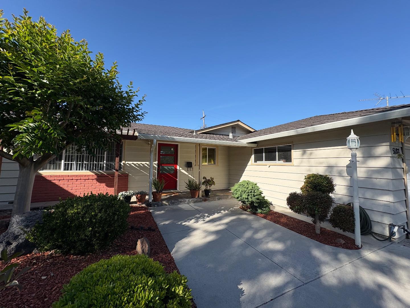 5187 Doyle Road San Jose, CA 95129 - Photo 2 of 39 a front view of a house with a yard
