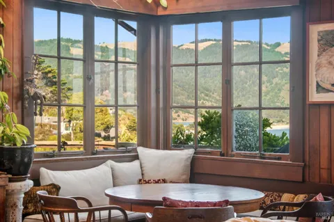 a bedroom with a bed and a large window with garden view