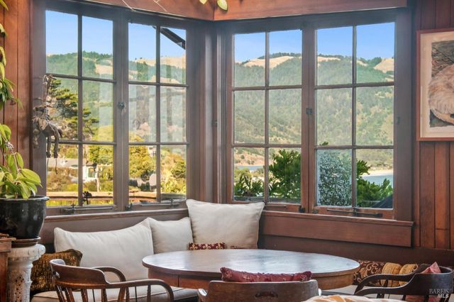a bedroom with a bed and a large window with garden view