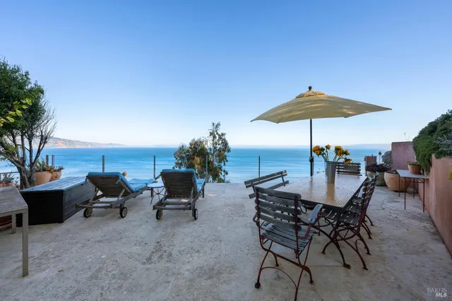 a view of a terrace with furniture and a table