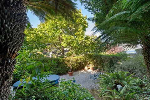 a view of a backyard with outdoor seating