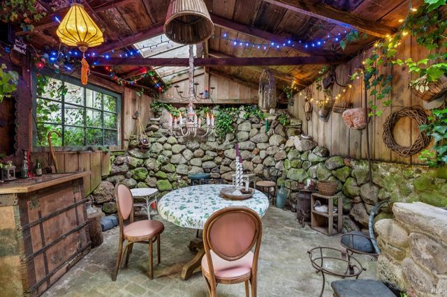 a view of a patio with table and chairs and potted plants