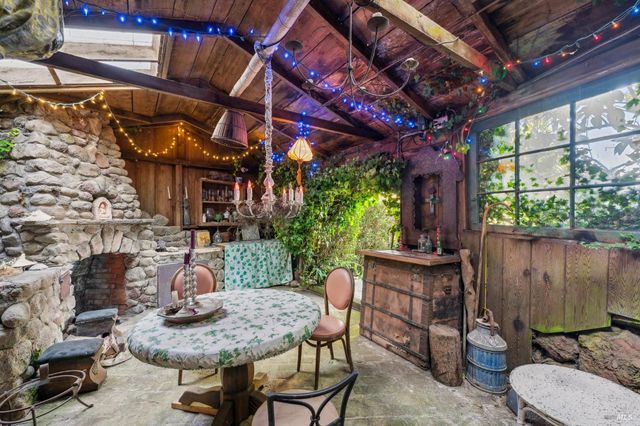 a view of a patio with table and chairs with wooden floor and plants