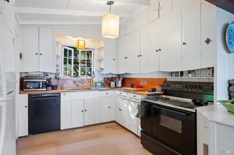 a kitchen with stainless steel appliances a stove a sink and a refrigerator