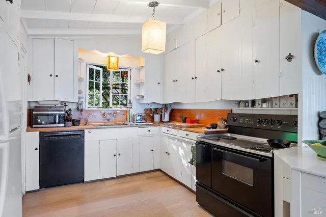 a kitchen with stainless steel appliances a stove a sink and a refrigerator
