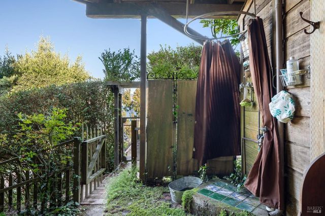 a view of a balcony with chair and potted plants