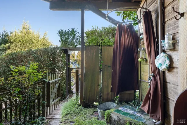 a view of a balcony with chair and potted plants
