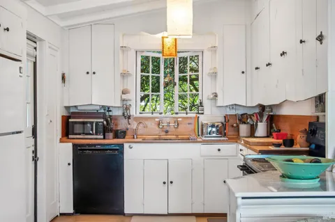 a kitchen with stainless steel appliances granite countertop a sink and a stove