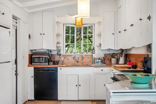 a kitchen with stainless steel appliances granite countertop a sink and a stove