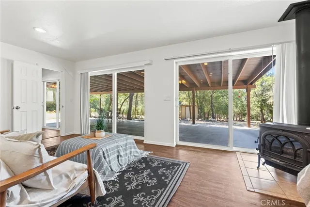 a spacious bedroom with a large window and a wooden floor