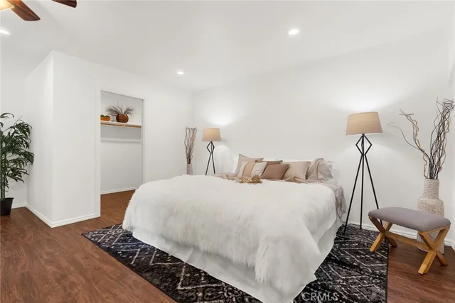 a bedroom with a bed and a potted plant