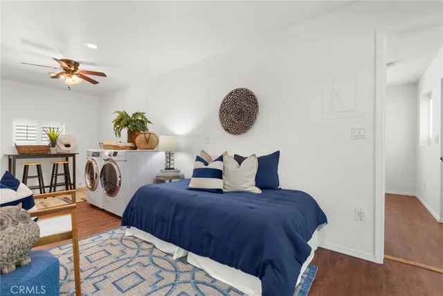 a bedroom with bed and wooden floor
