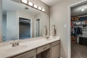 a bathroom with a double vanity sink and a mirror