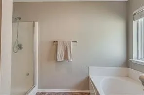 a bathroom with a tub and shower
