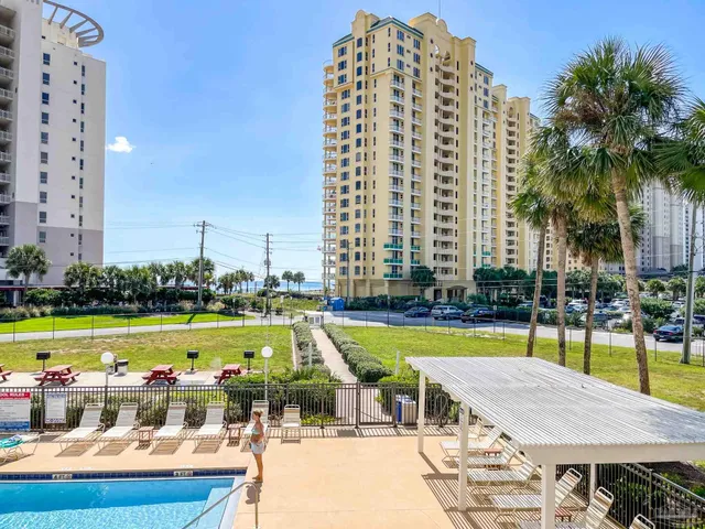 a view of a chairs and table in the balcony