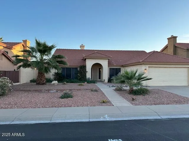 a view of a livingroom with wooden floor a ceiling fan and a fireplace