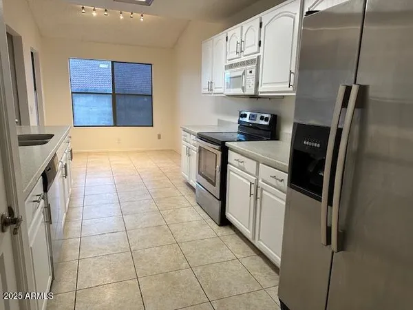 a kitchen with a sink a counter top space and cabinets