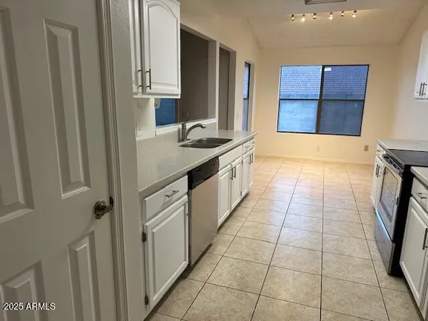 a kitchen with a sink and a stove top oven