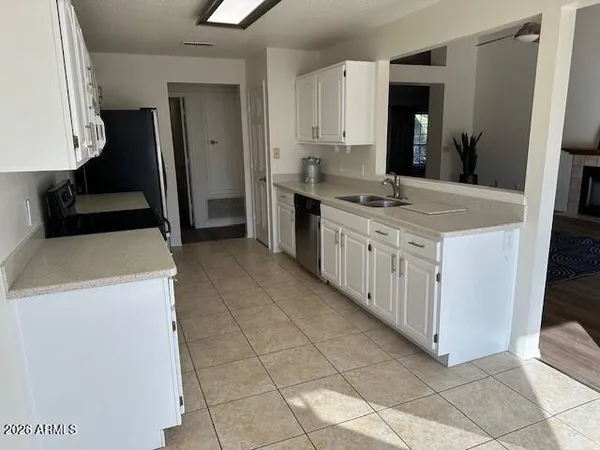 a kitchen with stainless steel appliances a stove a sink and a refrigerator