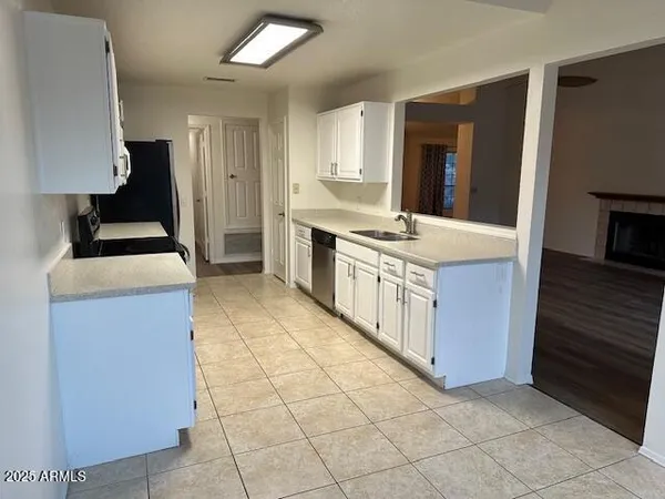 a kitchen with a stove sink and a refrigerator