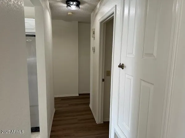 a view of a hallway with a hardwood