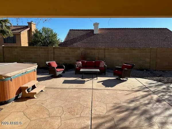 a backyard of a house with table and chairs