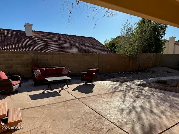 a view of swimming pool with a lounge chair and palm trees