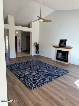 a view of a livingroom with wooden floor and a rug