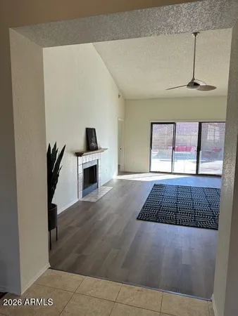 a view of an empty room with a fireplace and a window