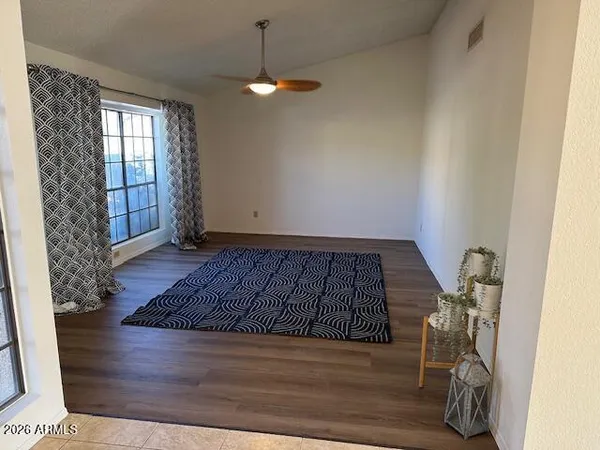 a spacious bedroom with a bed and a chandelier