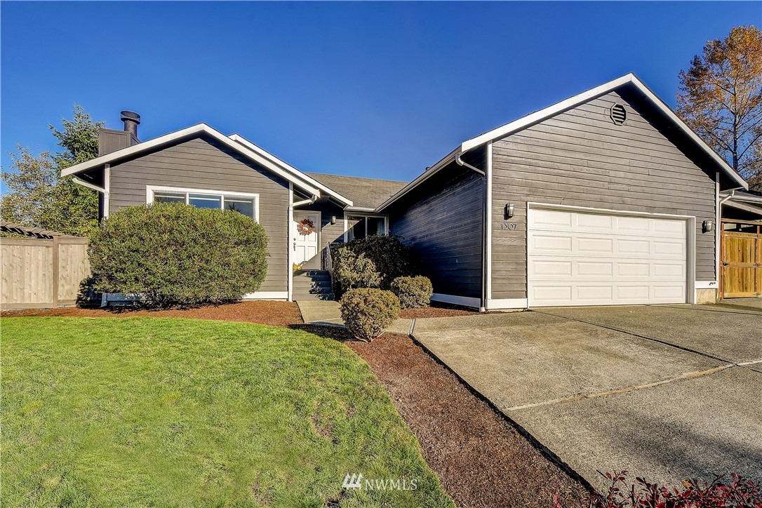 1307 221st Place Southwest Bothell, WA 98021 - Photo 1 of 20 a front view of a house with garden