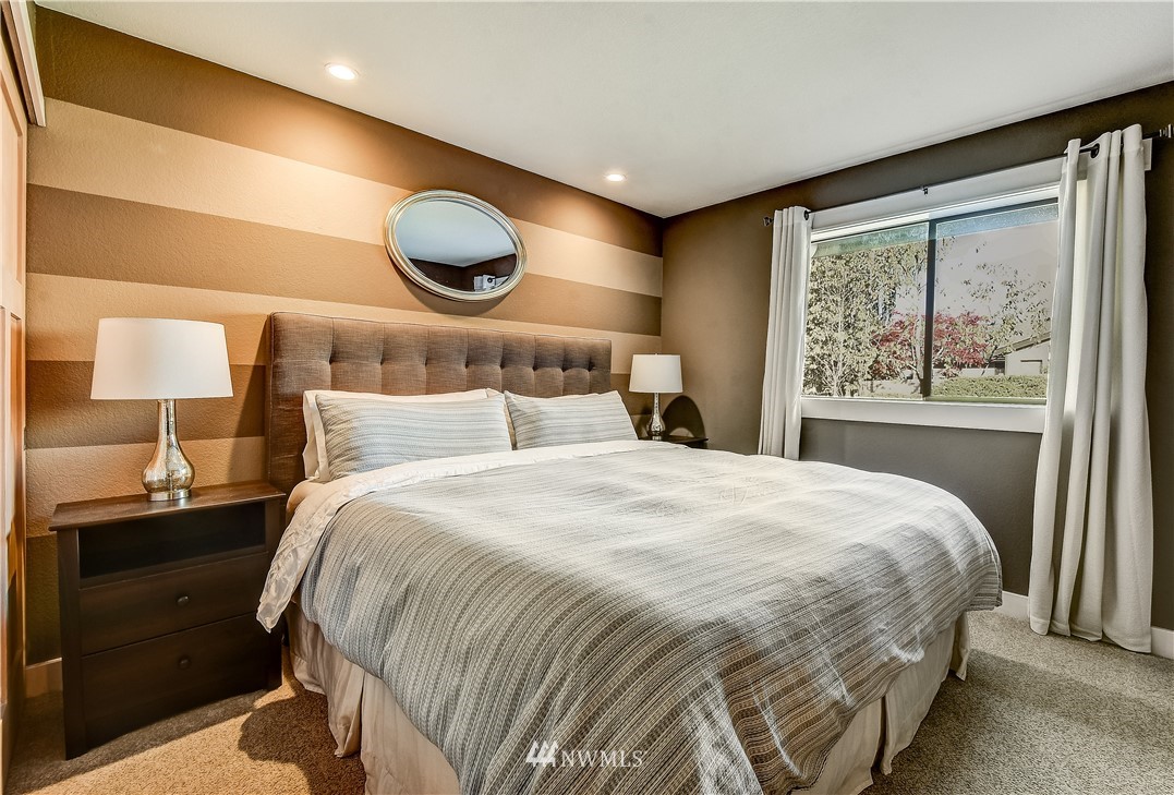 1307 221st Place Southwest Bothell, WA 98021 - Photo 12 of 20 a bedroom with a large bed and a large window
