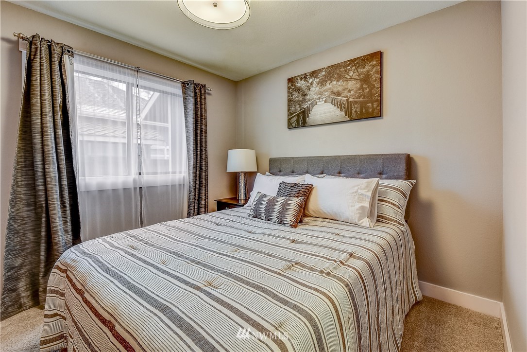 1307 221st Place Southwest Bothell, WA 98021 - Photo 15 of 20 a bedroom with a large bed and a window