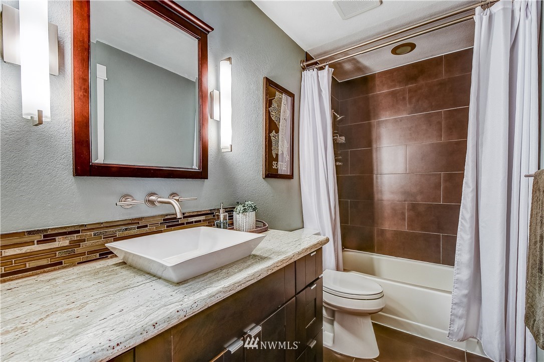 1307 221st Place Southwest Bothell, WA 98021 - Photo 16 of 20 a bathroom with a sink a toilet and shower